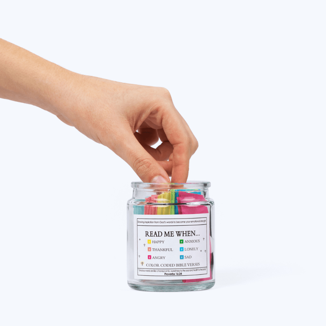 Hand picking a color-coded Bible verse from the scripture jar for daily encouragement