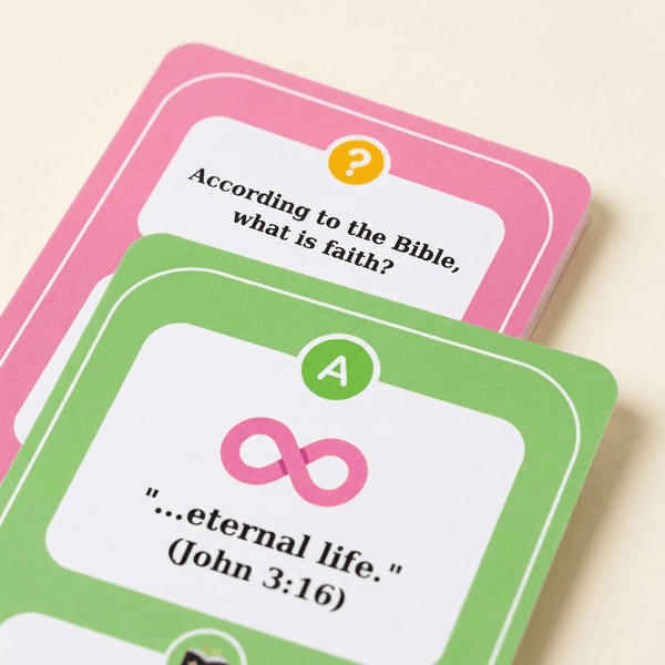 Two question cards from a game, one pink and one green, with text and symbols.