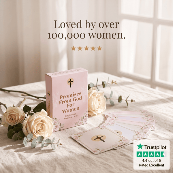 A boxed card deck titled "Promises From God For Women" sits on a bed with cream roses and eucalyptus stems in a softly lit bedroom. Text above reads "Loved by over 100,000 women.