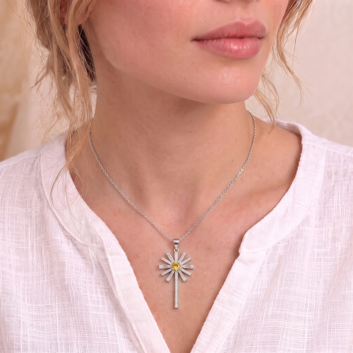 Hannah sunburst cross necklace on the neck