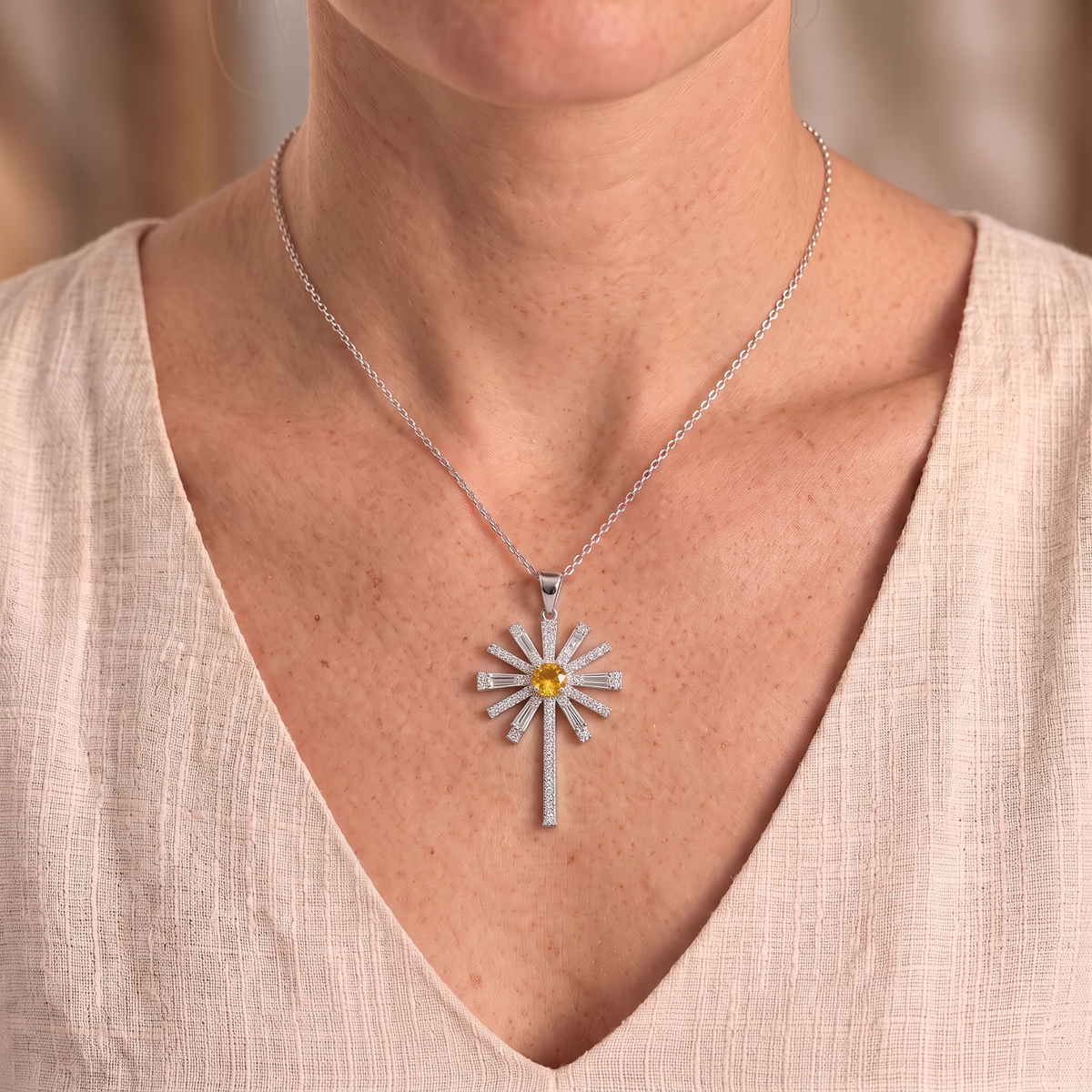 Hannah sunburst cross necklace worn close-up
