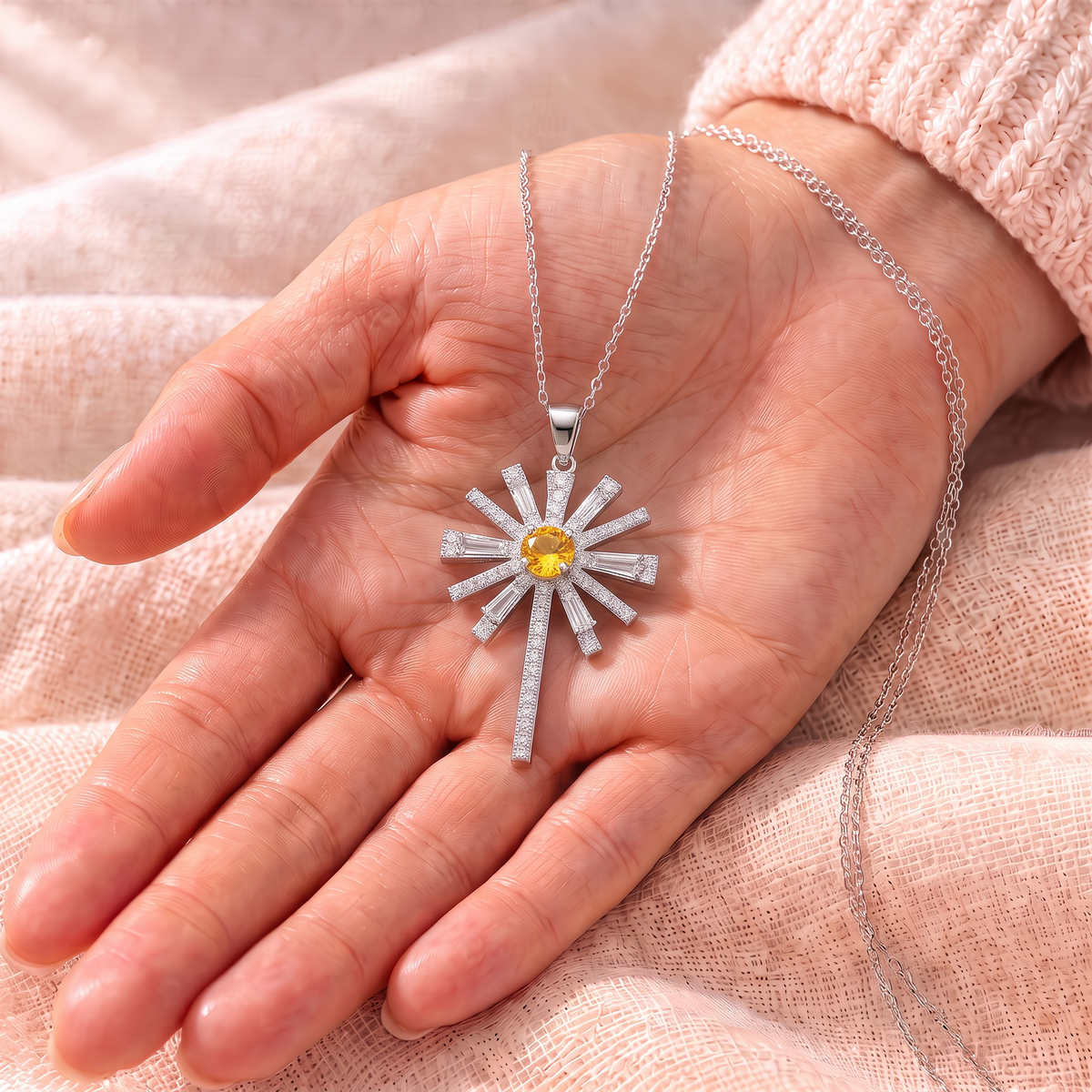 Hannah sunburst cross pendant in the palm
