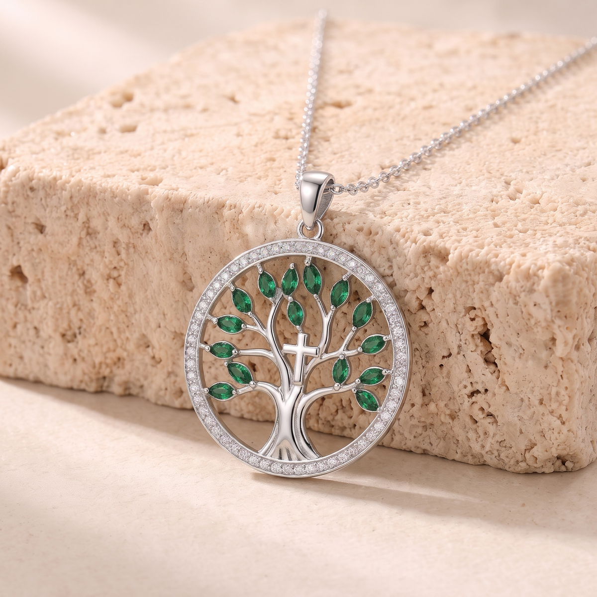 Naomi green zircon tree of life necklace on travertine