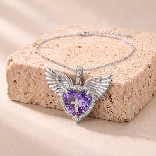 Abigail violet zircon winged heart necklace on travertine