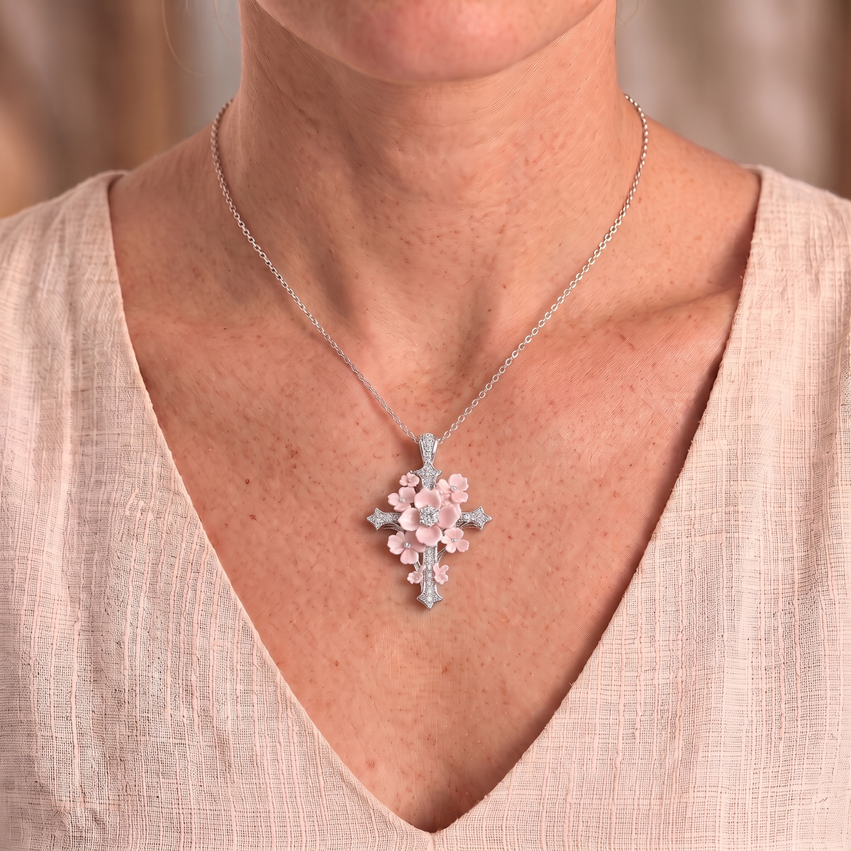 Lydia flower cross necklace worn close-up