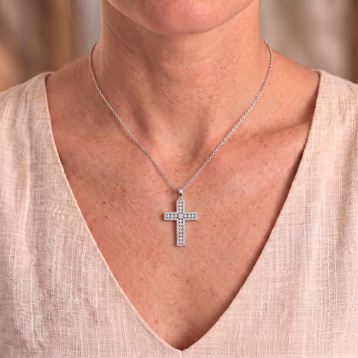 Phoebe moissanite cross necklace worn close-up