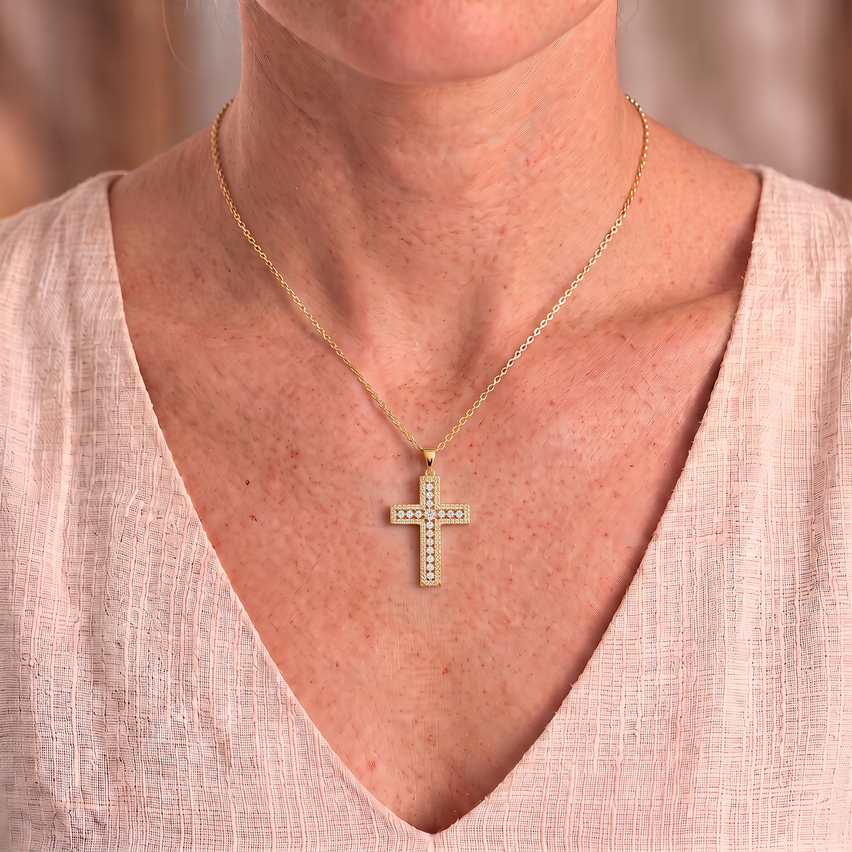 Phoebe moissanite cross necklace in gold worn close-up