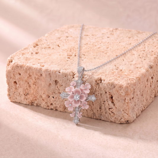 Lydia pink zircon flower cross necklace on travertine